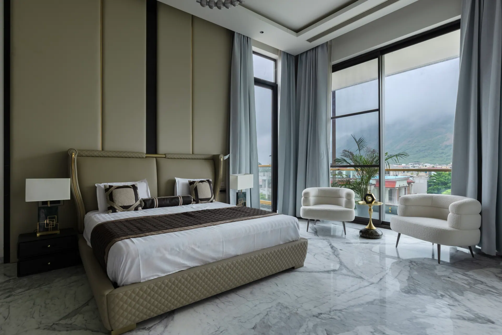 Bedroom with large aluminium windows and a mountain view